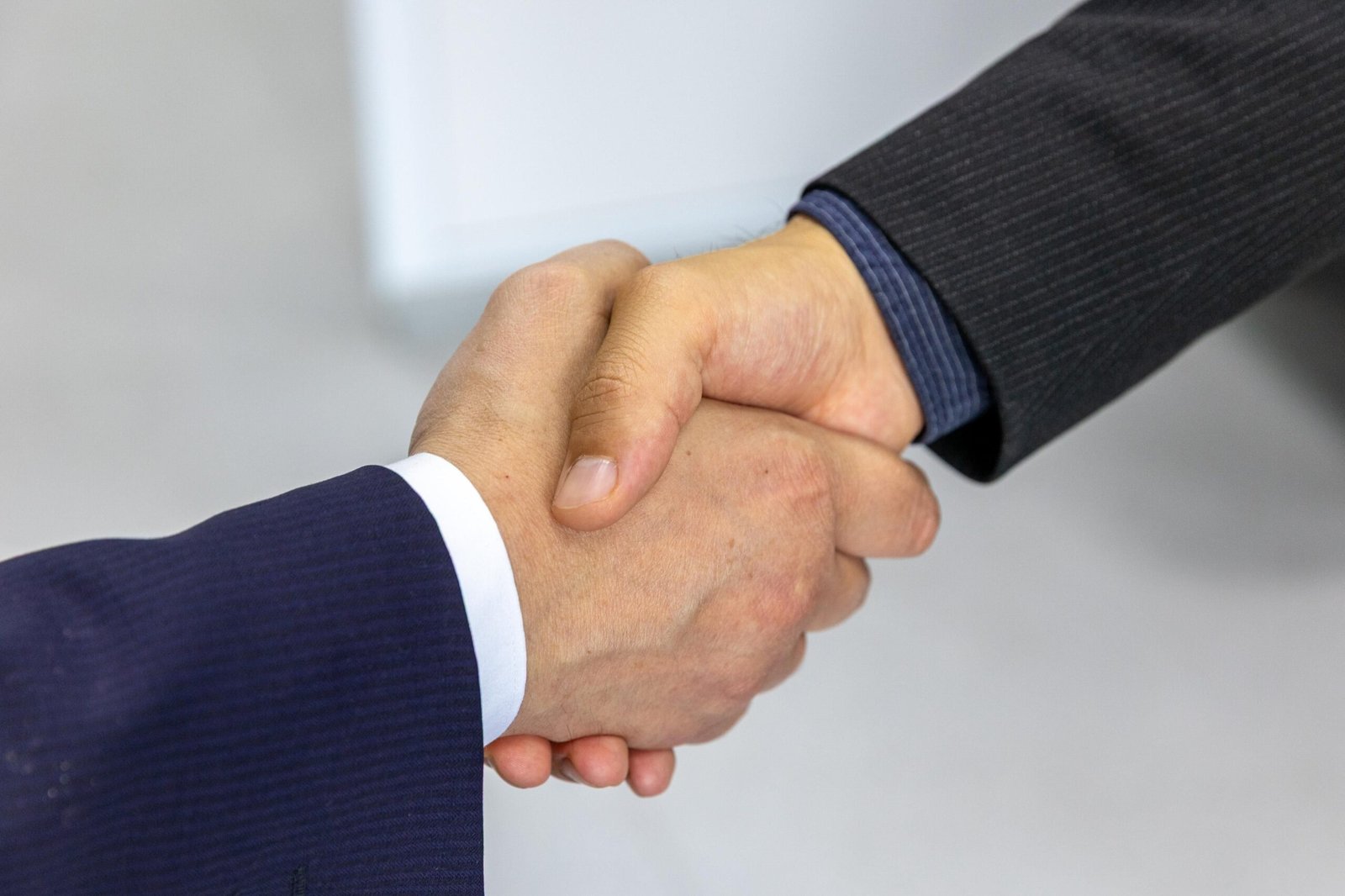 Two business professionals shaking hands after a successful deal