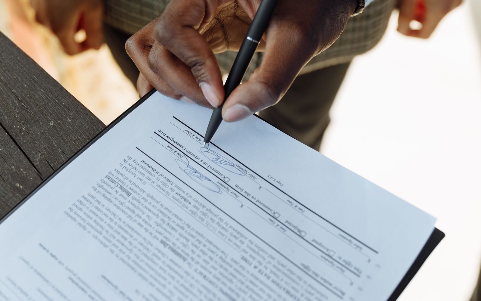 Person signing a property contract – freehold vs leasehold (patta) property guide