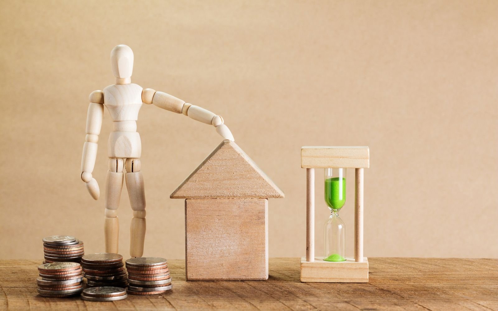 Money and house model – hidden costs while buying property