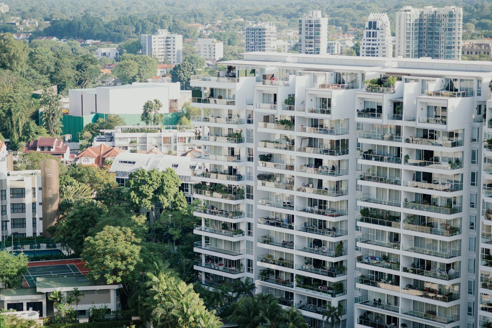 Modern apartment buildings with balconies and trees – representative image